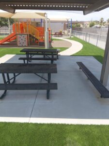 Artificial turf border around a shaded picnic ramada