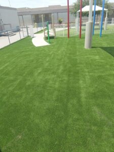 Finished artificial turf lawn with concrete path on the last day of install